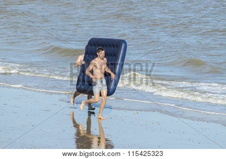 Friends running on the beach