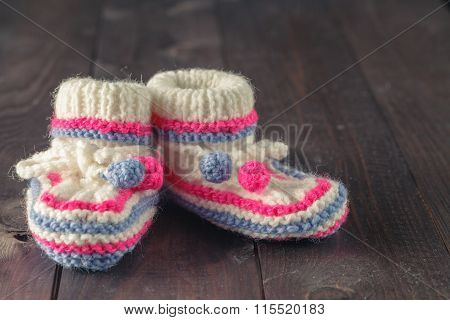 Baby Booties On Rustic Wooden Background
