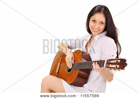 Unge smukke smilende Brunette dame i hvid Chemise spiller akustisk Guitar