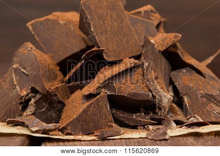 Dark chocolate with cacao on dark wooden table