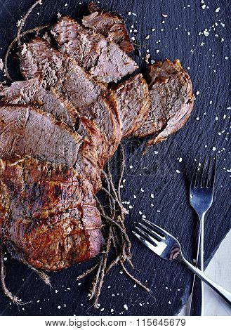 Roast beef on black stone board