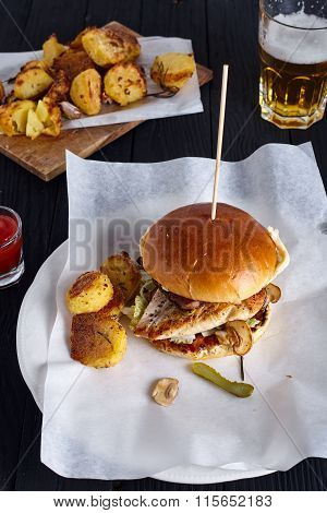 Burger with ketchup on wooden background