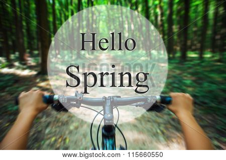 hello spring. a mountain bicycle descending quickly forest