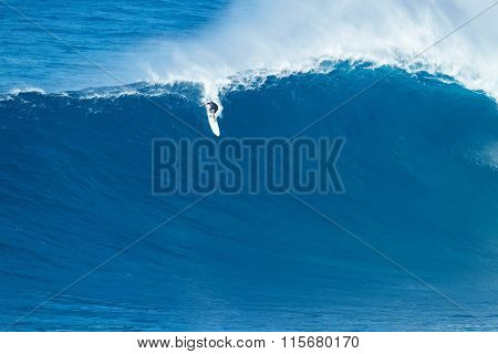 MAUI, HI - JANUARY 16 2016: Professional surfer Ian Walsh rides a giant wave at the legendary big wave surf break known as 