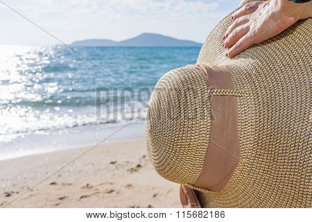 woman enjoying beach relaxing joyful in summer by tropical blue water.