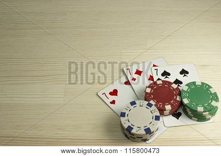 Poker Chips And Playing Cards On The Table. Focus On Cards