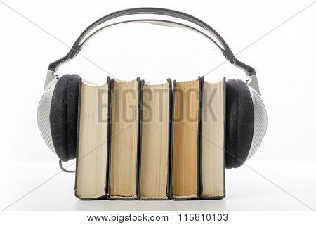 Audio book Stack of hardback books and electronic reader. Electronic library concept. Back to school