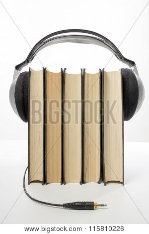 Audio book Stack of hardback books and electronic reader. Electronic library concept. Back to school