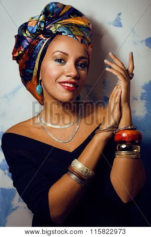 beauty bright african woman with creative make up, shawl on head like cubian woman