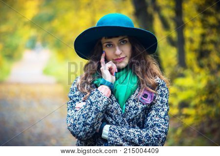 Thoughtful Brunette Girl Walking In The Autumn Park