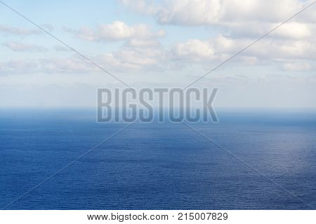 Beautiful White Clouds On Blue Sky Over Calm Sea With Sunlight Reflection, Bali Indonesia. Tranquil