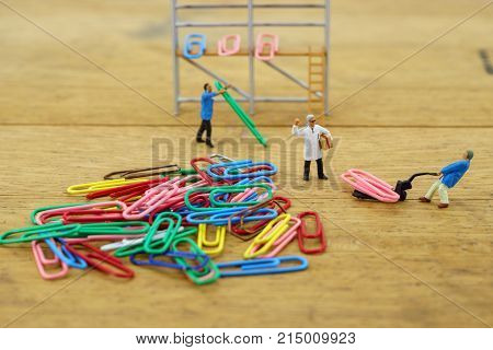The concept of a collective solution to any problem. Workers perform disposal of the Chief. Close-up view.