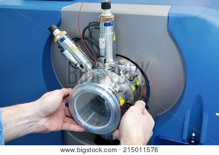 Adjust The Mass Spectrometer. The Man Analyzes The Device For Determining The Masses Of Atoms. Devic