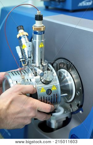 Adjust The Mass Spectrometer. The Man Analyzes The Device For Determining The Masses Of Atoms. Devic