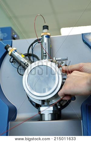 Adjust The Mass Spectrometer. The Man Analyzes The Device For Determining The Masses Of Atoms. Devic