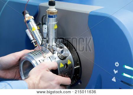 Adjust The Mass Spectrometer. The Man Analyzes The Device For Determining The Masses Of Atoms. Devic