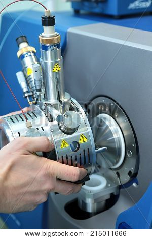 Adjust The Mass Spectrometer. The Man Analyzes The Device For Determining The Masses Of Atoms. Devic