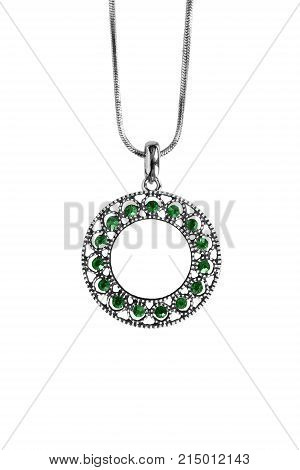 Vintage silver pendant with emeralds hanging on silver chain isolated over white