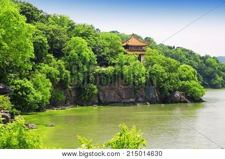 The rocky coast line of Taihu or Lake Tai scenic area in Wuxi China in Jiangsu province with an algae bloom near shore.