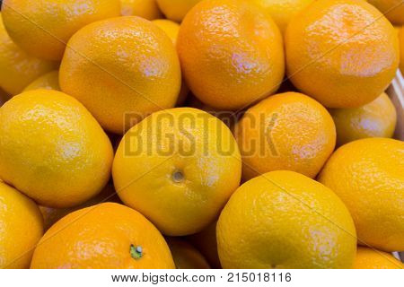 Fresh orange and yellow tangerines closeup close
