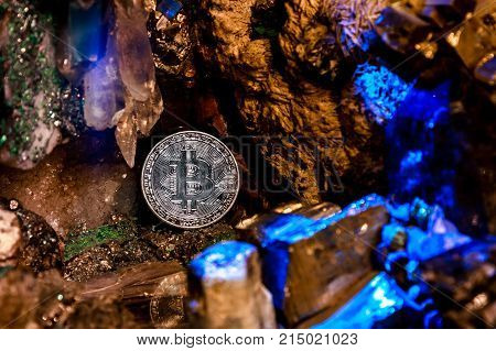 Silver bitcoin in a cave of precious stones. Bitcoin cryptocurrency.