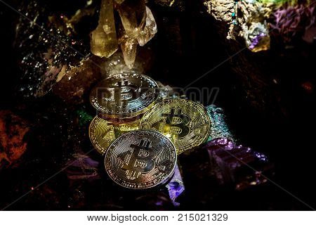 Silver and golden bitcoin in a cave of precious stones. Bitcoin cryptocurrency.