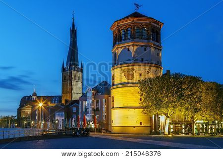 View of Dusseldorf historic center with Old Castle Tower and st Lambertus church in evening Germany