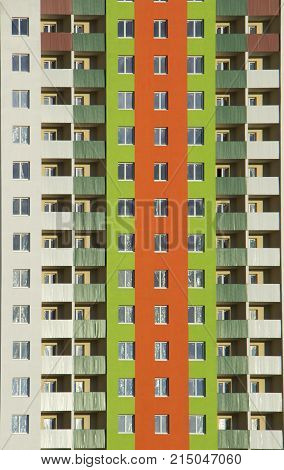 The facade of a typical block multi-storey residential building. Front view close up.