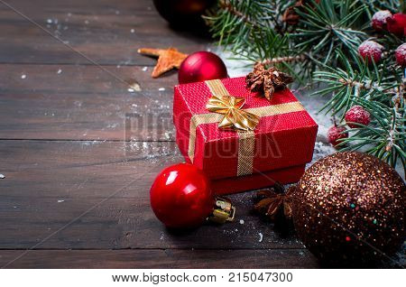 Red Christmas  Gift  Box With Red Ribbon And Fir Branches