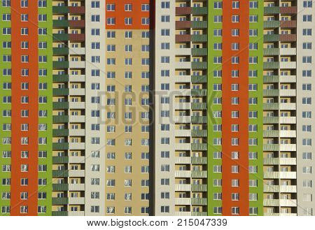 The facade of a typical block multi-storey residential building. Front view close up.