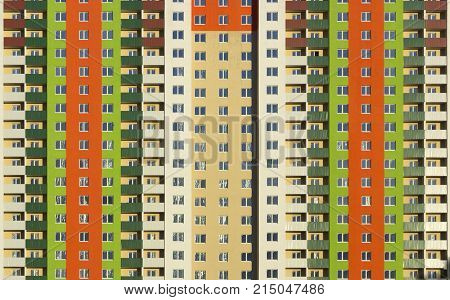 The facade of a typical block multi-storey residential building. Front view close up.