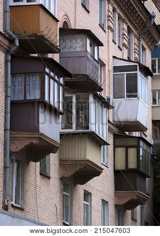 The facade of a typical block multi-storey residential building. Front view close up.