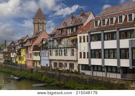 Wertheim am Main Germany - medieval city old houses on the waterfront of Tauber river against the blue cloudy sky - popular tourist destination