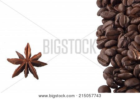 star anise, on the background of coffee with beautiful highlights on the surface of grains.