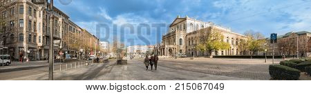 HANNOVER GERMANY - NOVEMBER 23 2017: Unidentified pedestrants cross the ganrd place in front of the opera house.