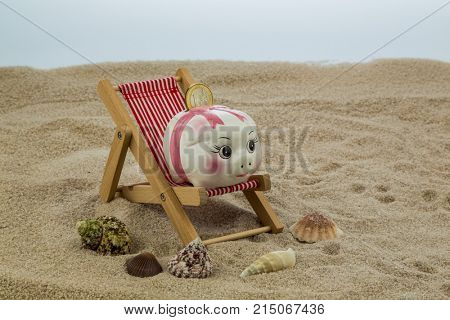 deck chair with piggy bank and euro