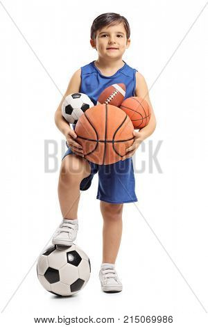 Full length portrait of a little boy holding different kinds of sports balls isolated on white background