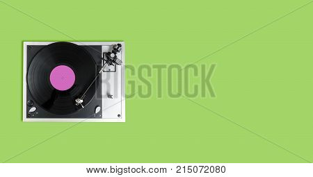 Aerial view top down onto a playing vinyl record on vintage hi-fi stereo disc turntable