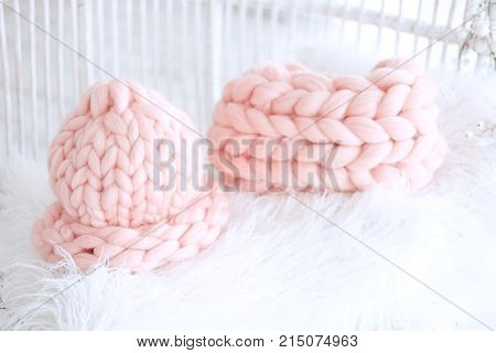 Knitted handmade winter accessories. Pink wool snood and hat.