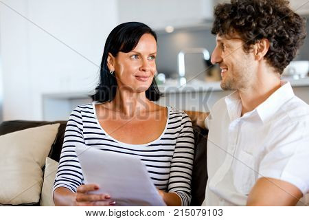 Couple with papers in their living room