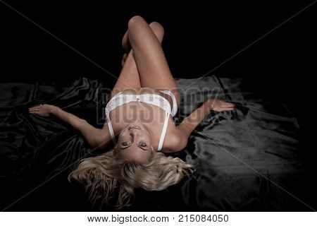 Beautiful Blond Woman On Bed With Black Saten Sheets