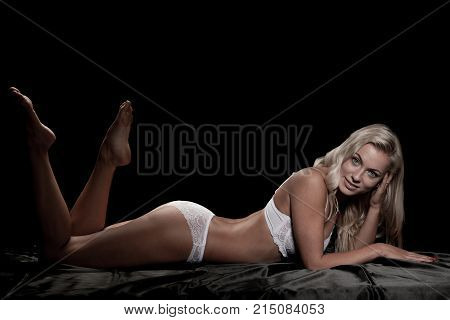 Beautiful Blond Woman On Bed With Black Saten Sheets