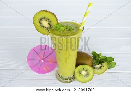 Kiwi Yogurt Healthy Fruit Smoothie Drink in the morning on a white wood background.
