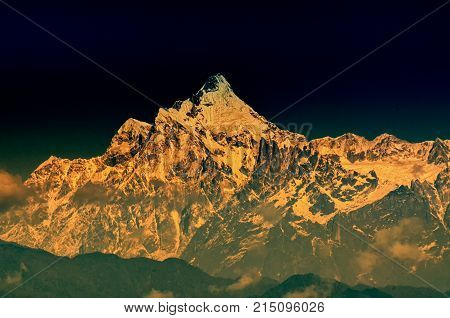 Beautiful first light from sunrise on Mount Kanchenjugha Himalayan mountain range Sikkim India. Orange tint on the mountains at dawn.