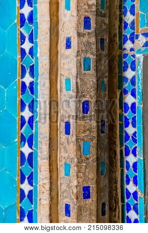 Old and traditional tiles as decoration at wall edges at the facade of the Yame mosque in old city Yazd in Iran.