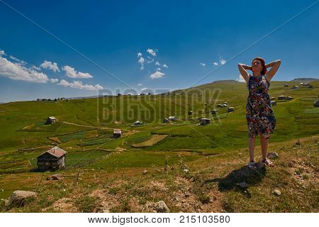 Young happy woman against mountain landscapes near Khulo village of Georgian Adjara region