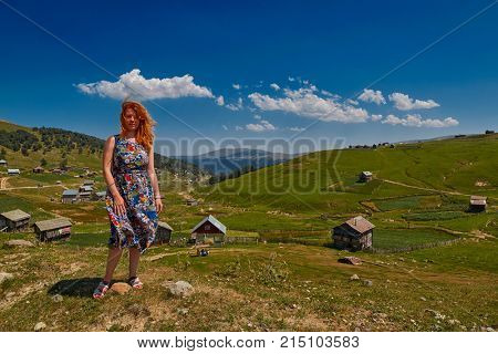 Young happy woman against mountain landscapes near Khulo village of Georgian Adjara region
