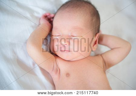 Cute Asian newborn baby sleeping, 1 week old.
