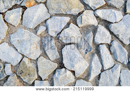 Texture of large gray sharp stones. The background