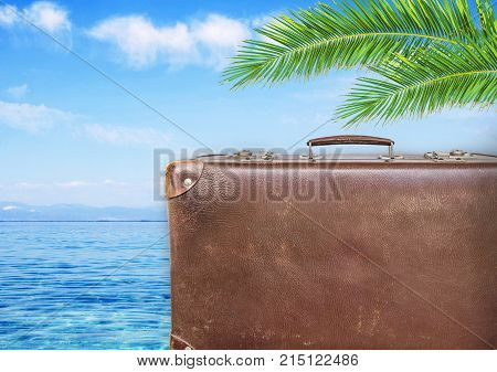Concept of summer traveling with old suitcase